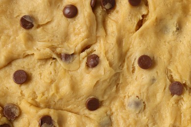 Texture of raw dough as background, closeup. Cooking chocolate chip cookies