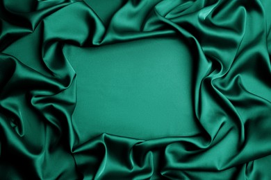Delicate green silk fabric as background, top view. Space for text