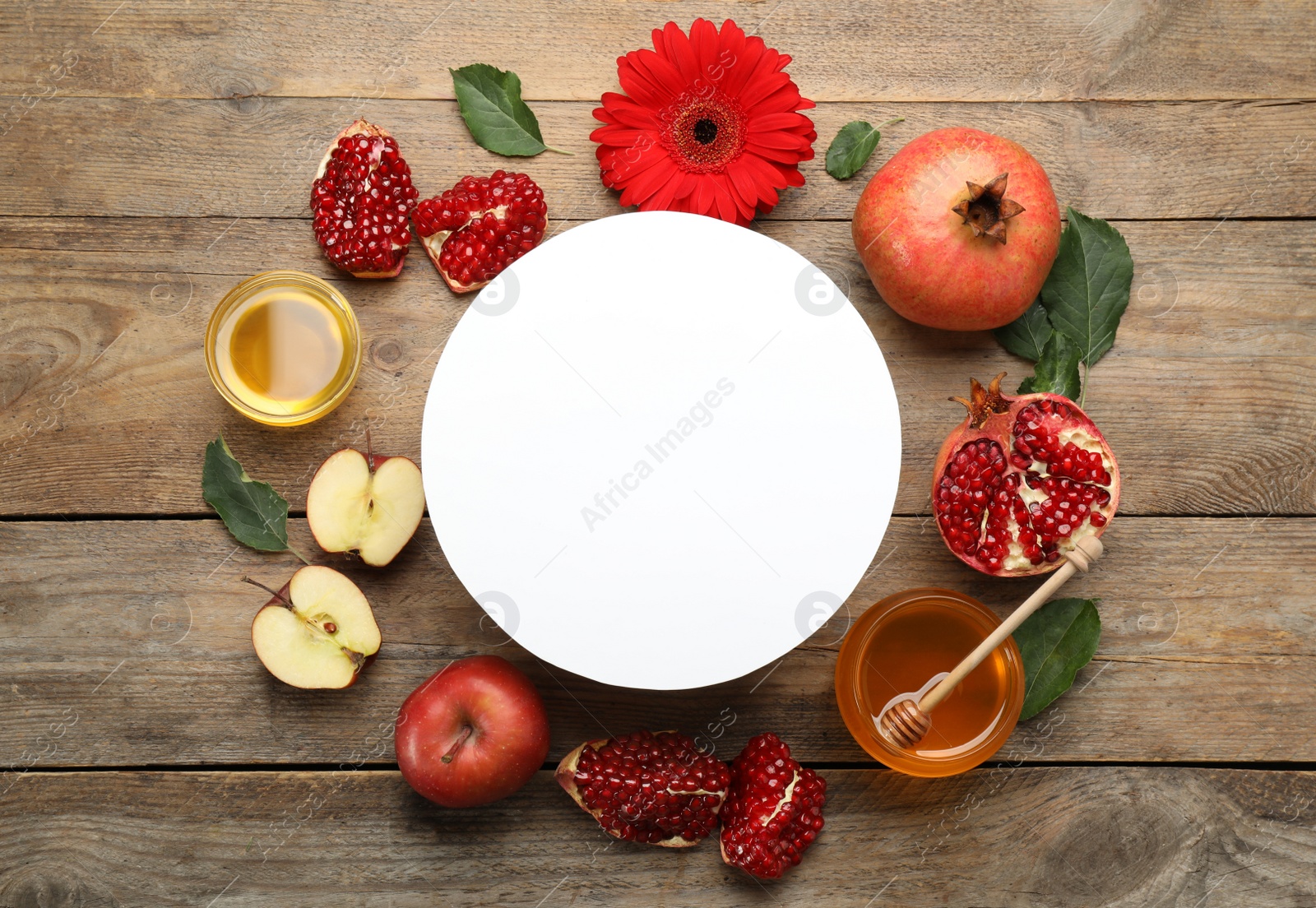 Photo of Flat lay composition with Rosh Hashanah holiday attributes and card on wooden table. Space for text