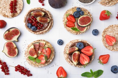 Photo of Flat lay composition with tasty crispbreads, mint, sweet berries and figs on light table