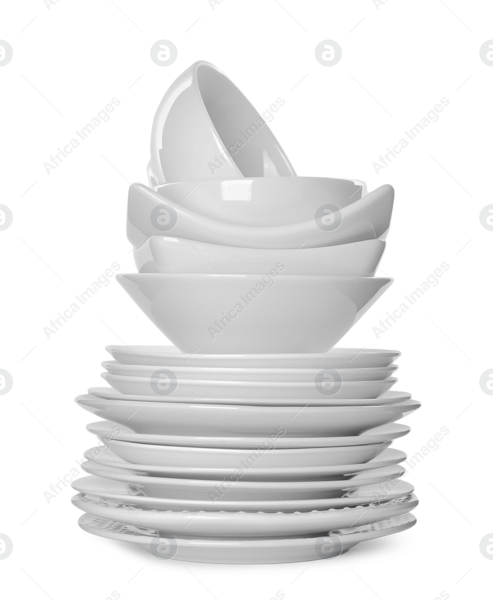 Photo of Stack of clean tableware isolated on white