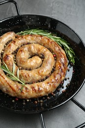 Tasty homemade sausages with spices on grey table, closeup