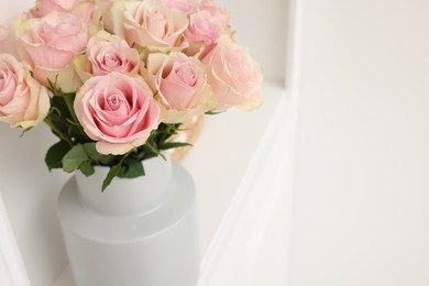 Photo of Beautiful bouquet of rose flowers on shelf in room, space for text. Interior design