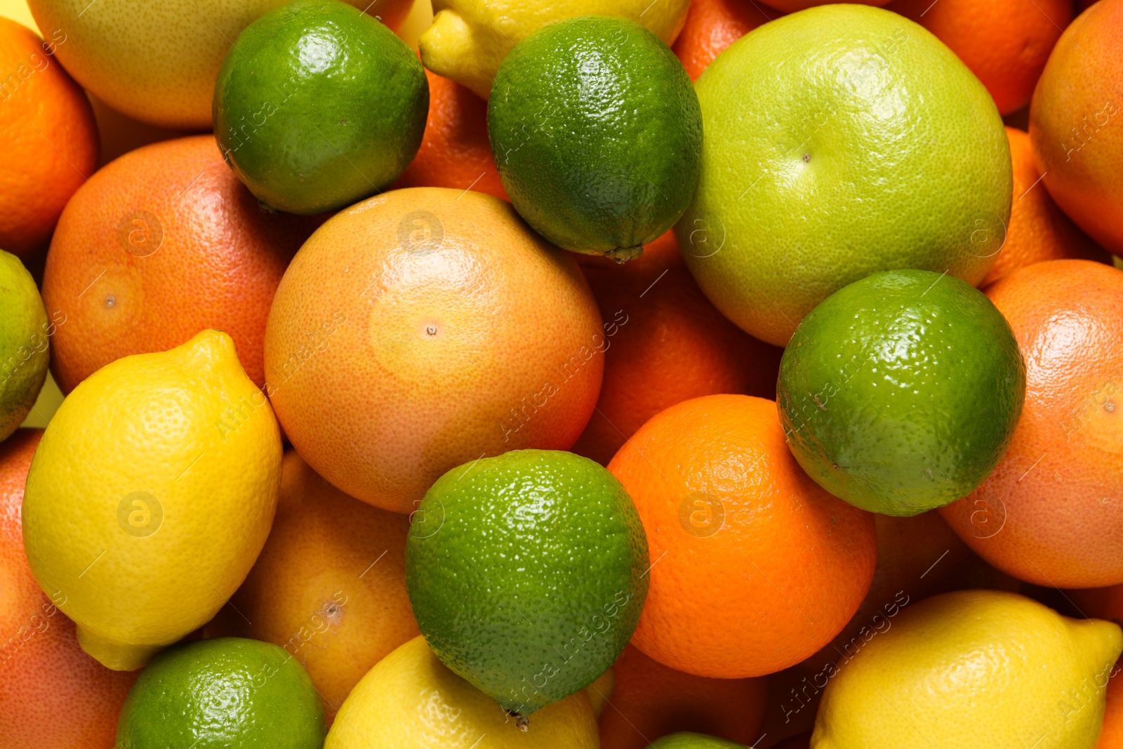 Photo of Different fresh citrus fruits as background, top view