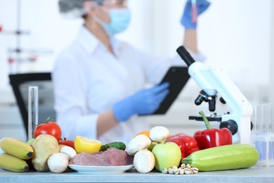 Photo of Fresh vegetables, fruits and meat on table in laboratory. Food quality control