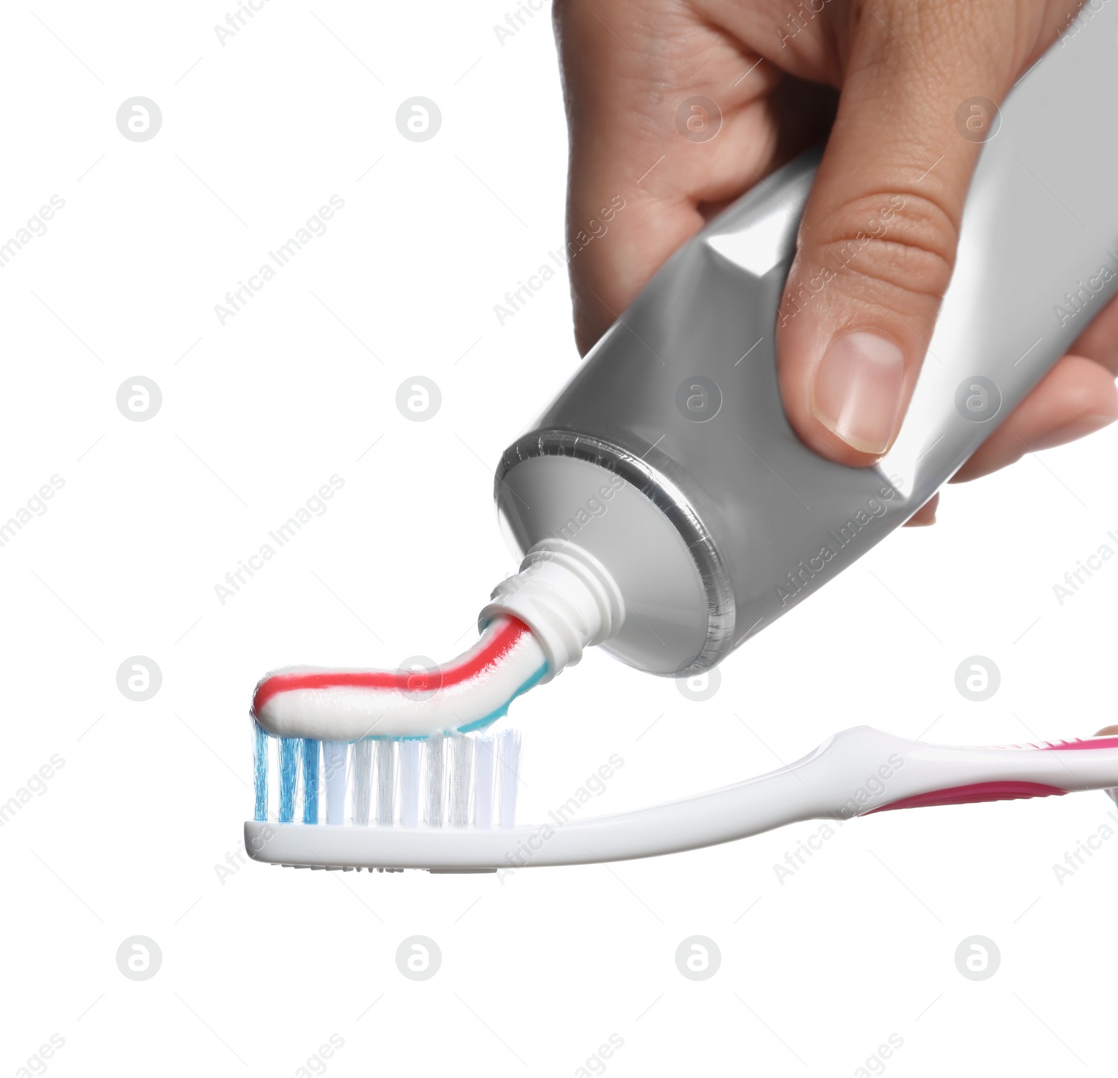 Photo of Woman applying toothpaste on brush against white background, closeup