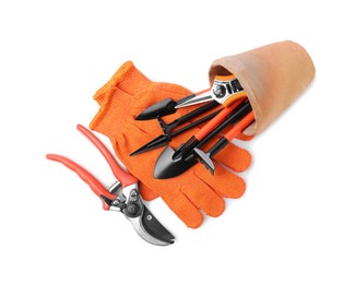 Photo of Pair of gloves and gardening tools on white background, top view