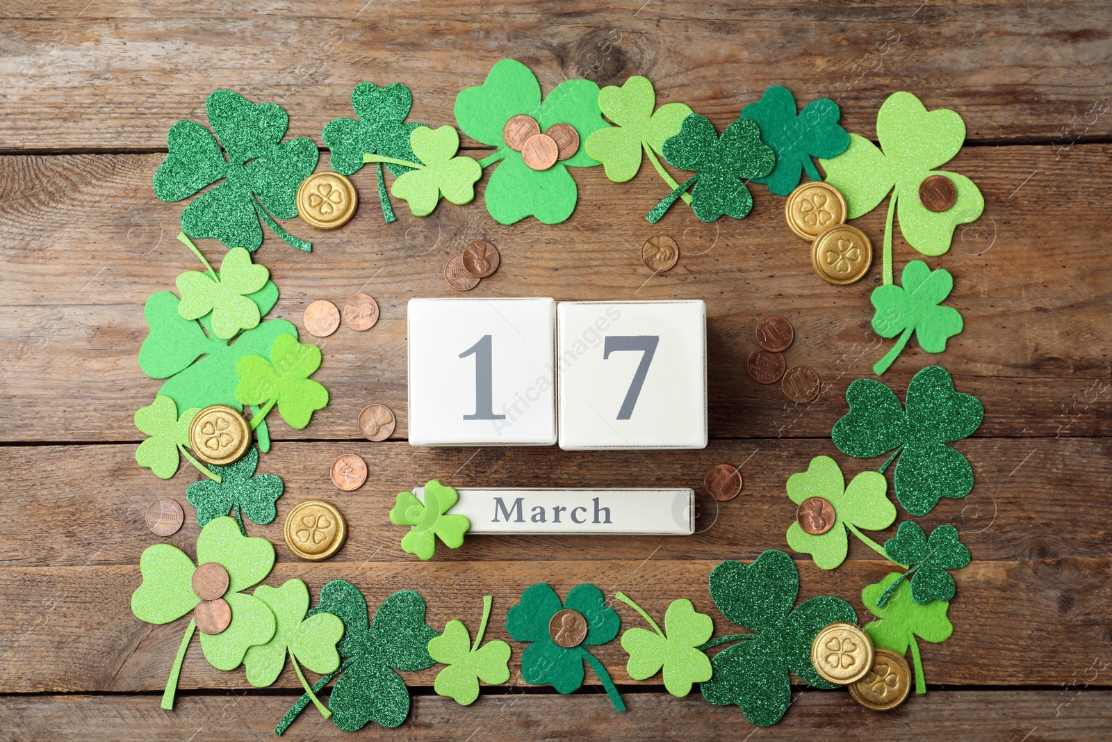 Photo of Flat lay composition with block calendar on wooden background. St. Patrick's Day celebration