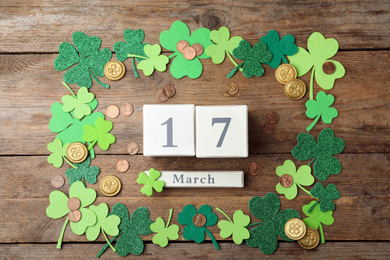 Flat lay composition with block calendar on wooden background. St. Patrick's Day celebration