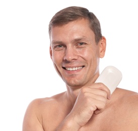 Portrait of man holding soap bar on white background