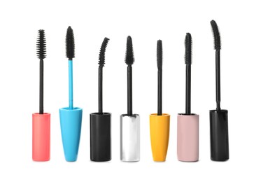 Photo of Many mascara wands for eyelashes on white background. Makeup product