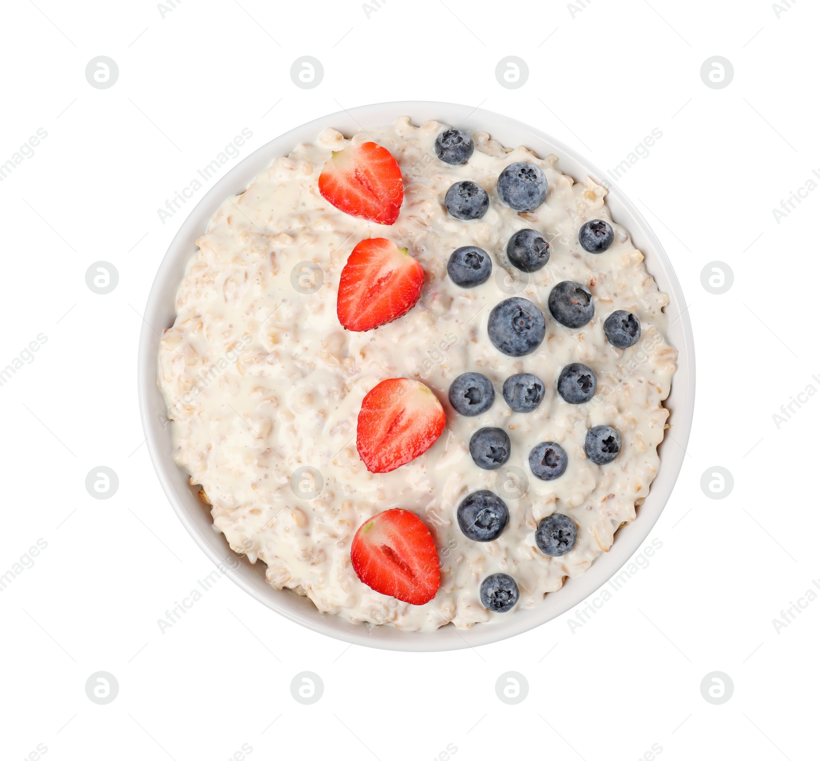 Photo of Tasty boiled oatmeal with berries in bowl isolated on white, top view