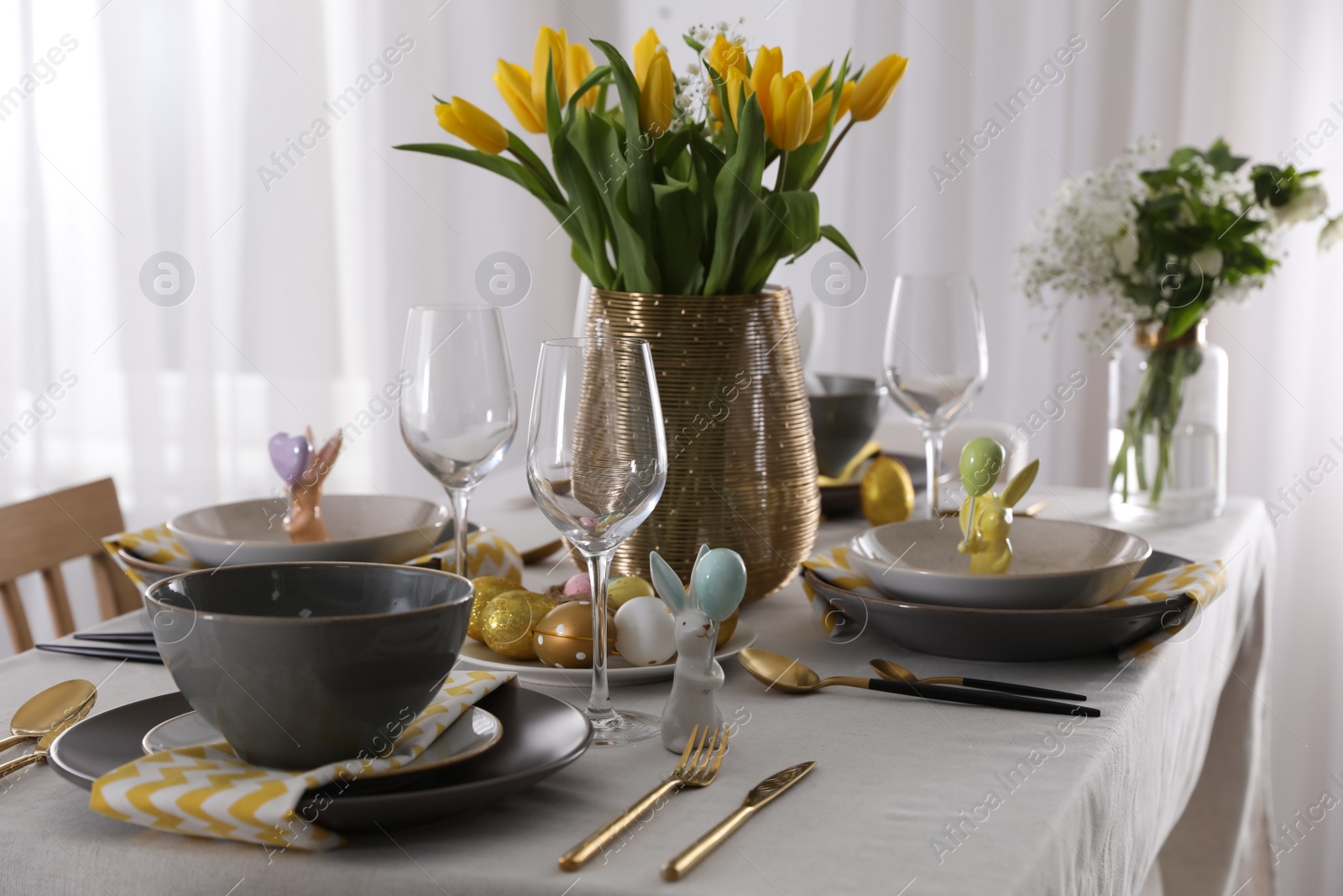 Photo of Beautiful Easter table setting with festive decor indoors