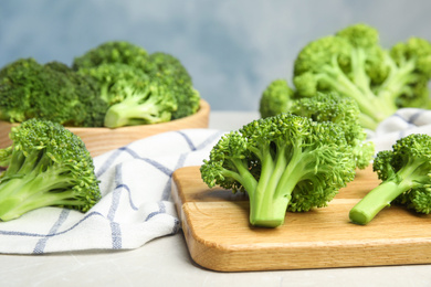 Photo of Fresh green broccoli on light marble table
