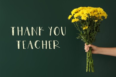 Woman holding beautiful bouquet near green chalkboard with phrase Thank You Teacher, closeup