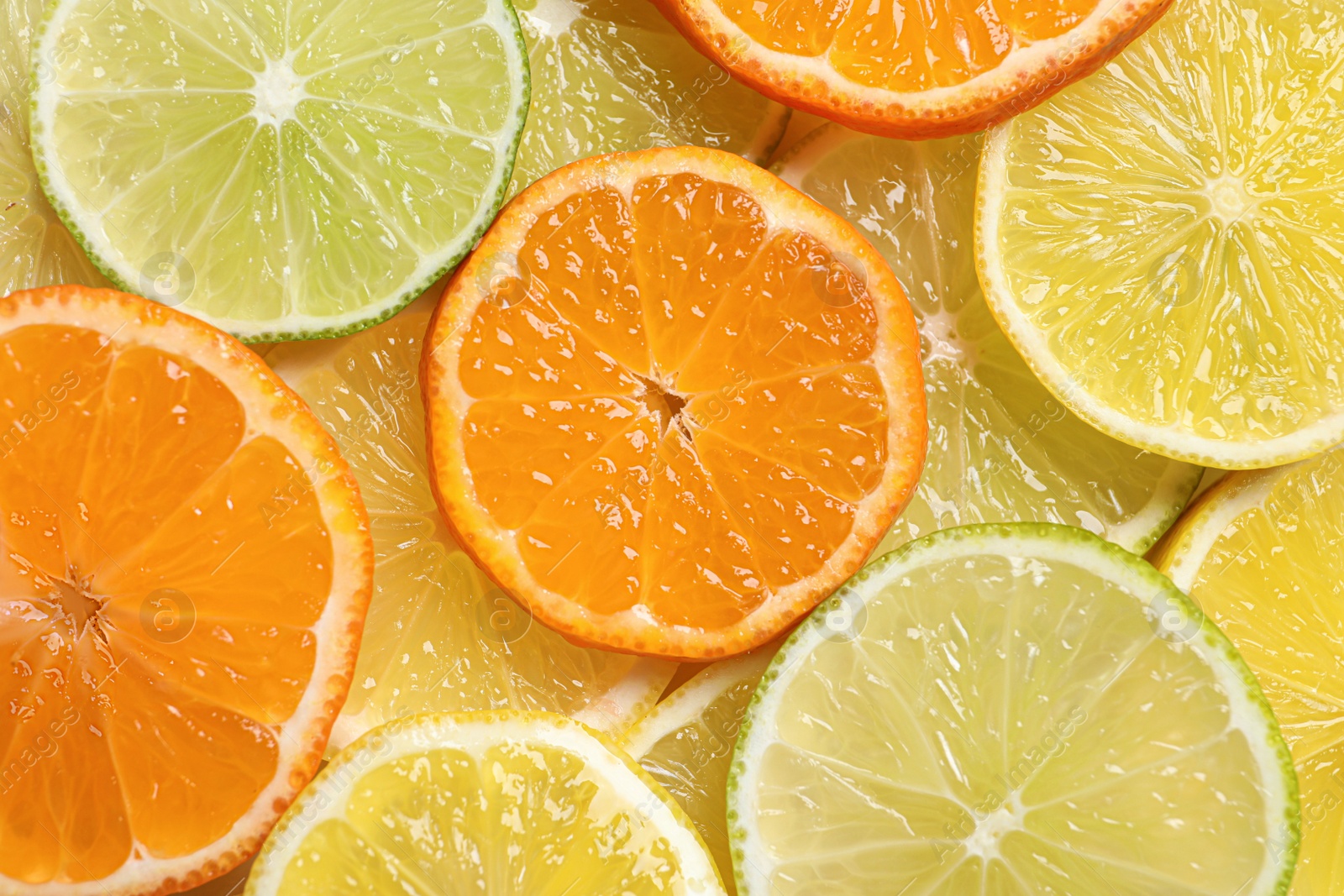 Photo of Slices of different citrus fruits as background, top view