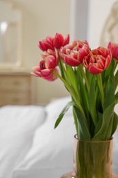 Photo of Bouquet of beautiful pink tulips in room, closeup