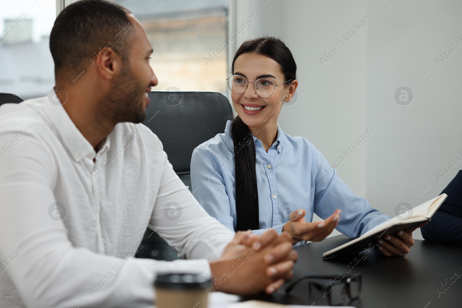 Photo of Lawyers working together at table in office