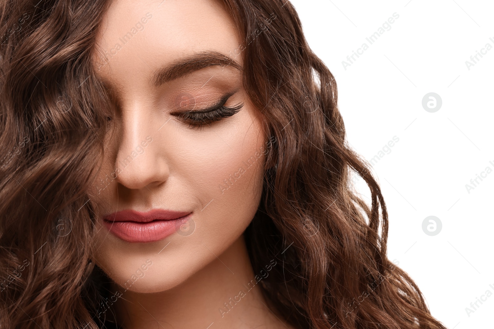 Photo of Beautiful young woman with long curly brown hair on white background, closeup