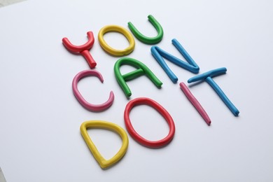 Motivational phrase You Can Do IT made of colorful plasticine on white background