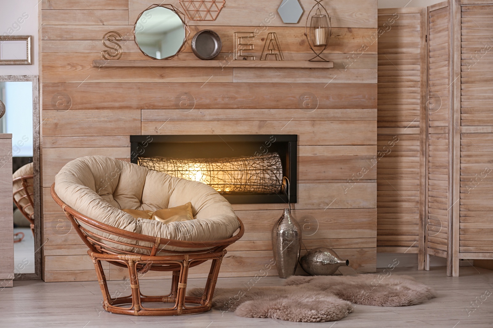 Photo of Cozy living room interior with comfortable papasan chair and decorative fireplace