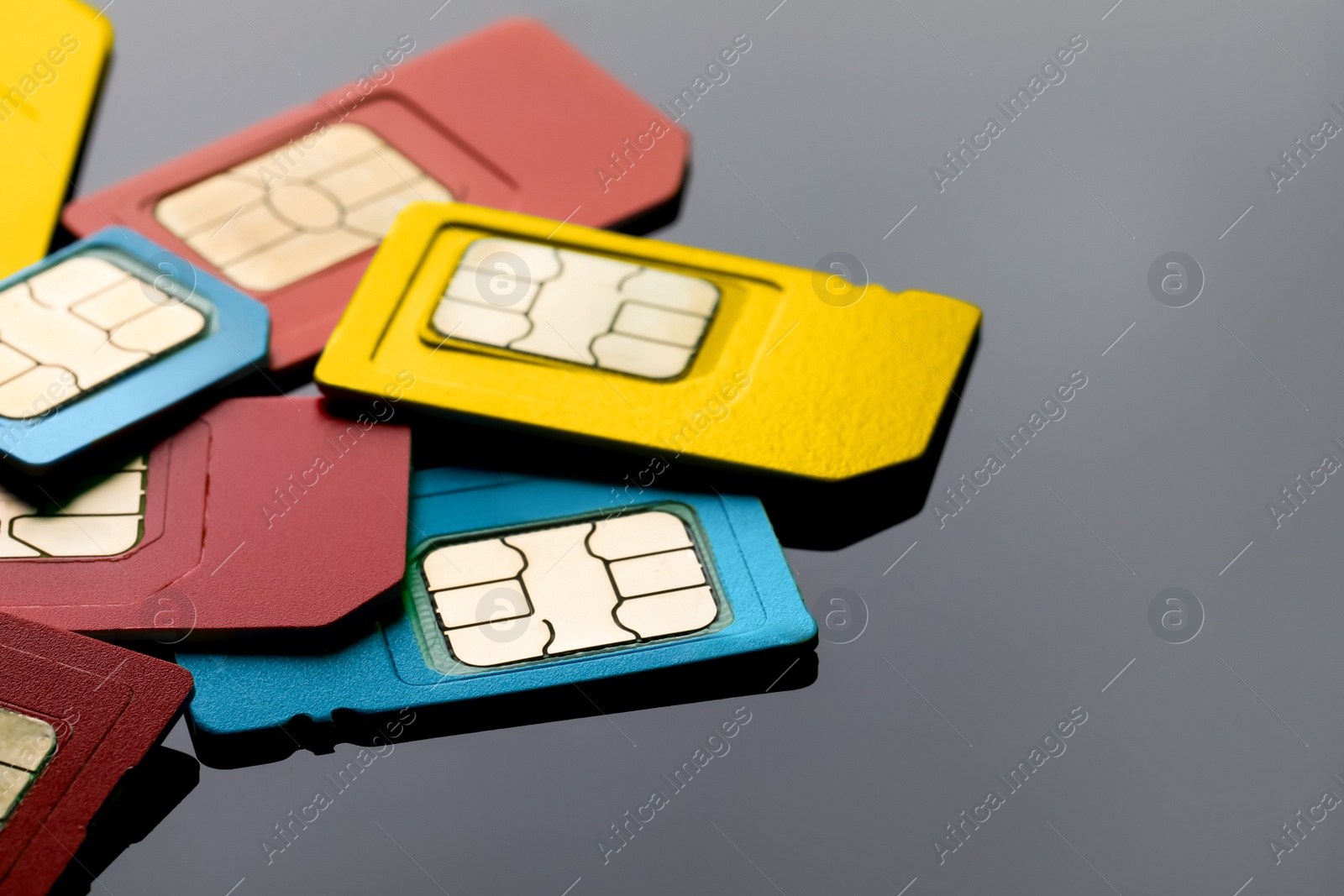 Photo of Different SIM cards on grey background, closeup