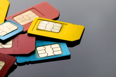 Photo of Different SIM cards on grey background, closeup