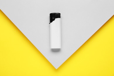 Photo of Stylish small pocket lighter on color background, top view