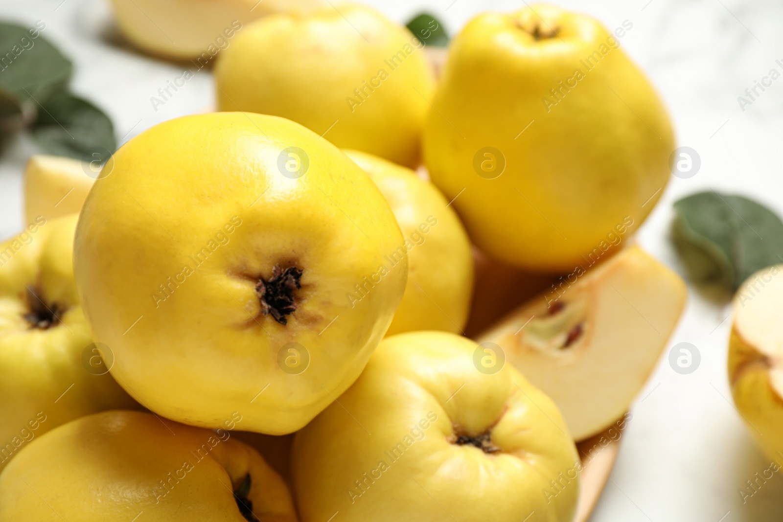 Photo of Fresh ripe organic quinces on table, closeup