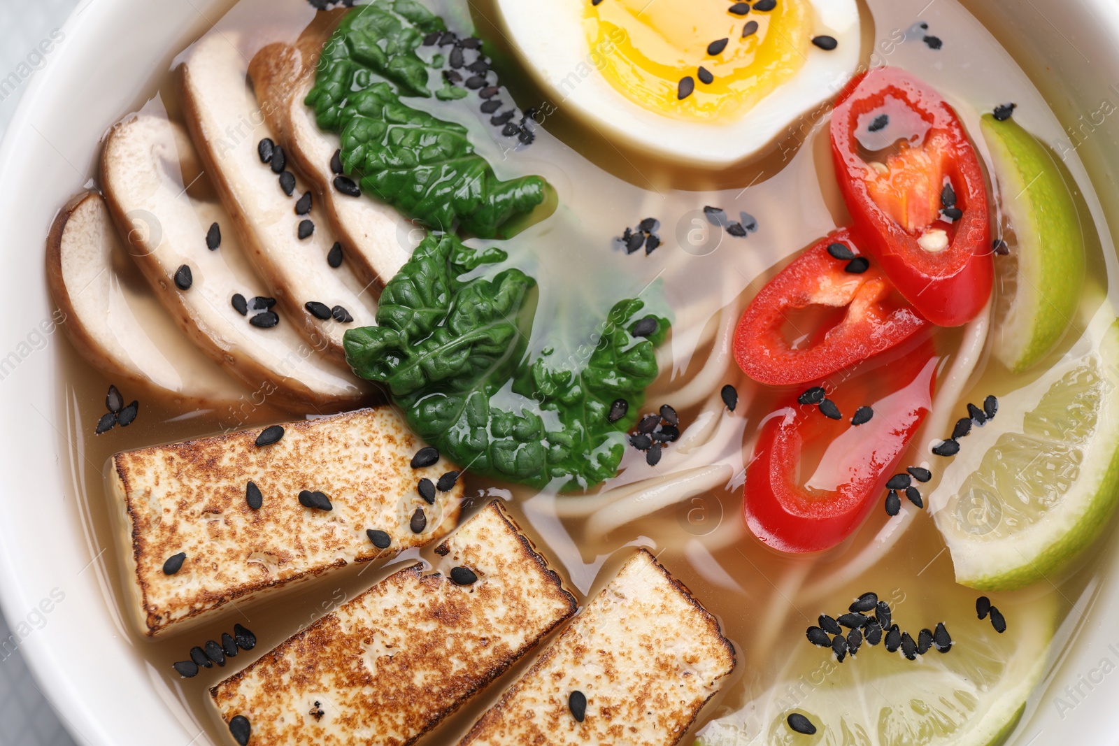 Photo of Delicious vegetarian ramen in bowl, top view