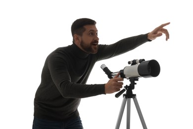 Happy astronomer with telescope pointing at something on white background