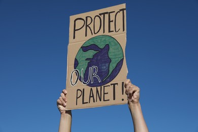 Photo of Man with poster protesting against climate change outdoors, closeup