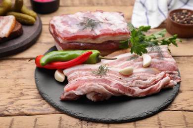 Photo of Pork fatback and ingredients on wooden table