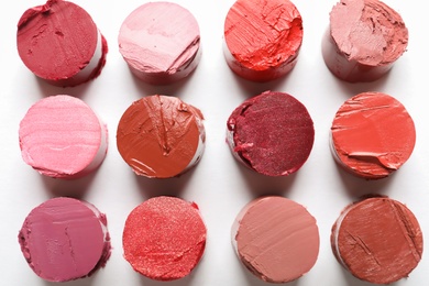 Photo of Different lipstick swatches on white background, top view