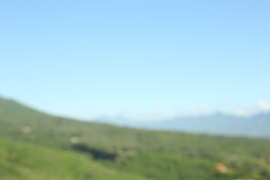 Photo of Blurred view of high mountains on sunny day