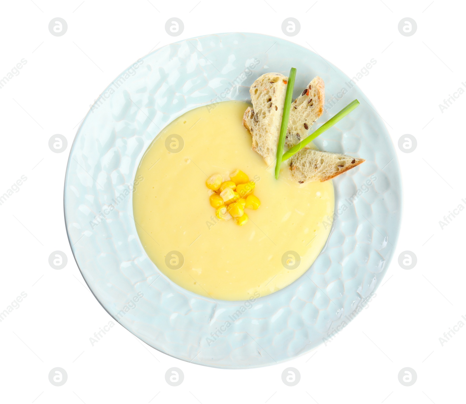 Photo of Delicious corn cream soup isolated on white, top view