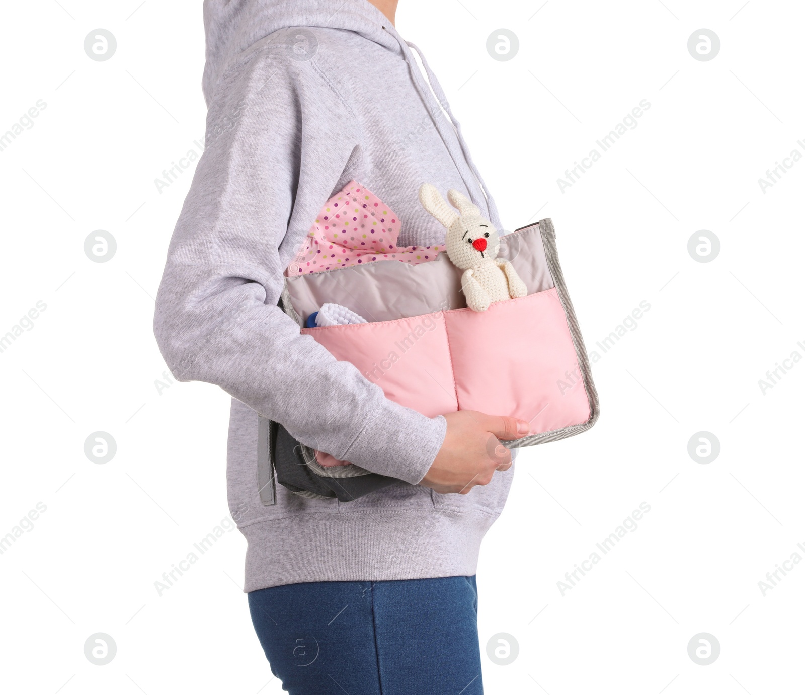 Photo of Woman holding maternity bag with baby accessories on white background, closeup