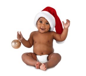 Photo of Cute African-American baby wearing Santa hat with Christmas decoration on white background