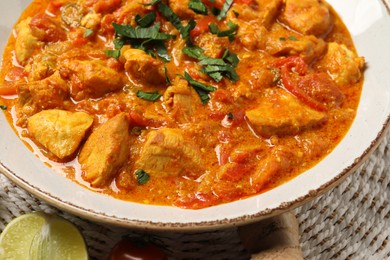 Photo of Delicious chicken curry with parsley on table, closeup