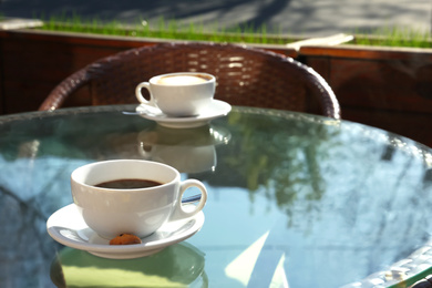 Photo of Cup of fresh aromatic coffee at table in cafe