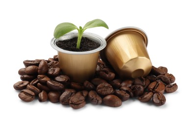 Photo of Green seedling growing in coffee capsule and beans isolated on white