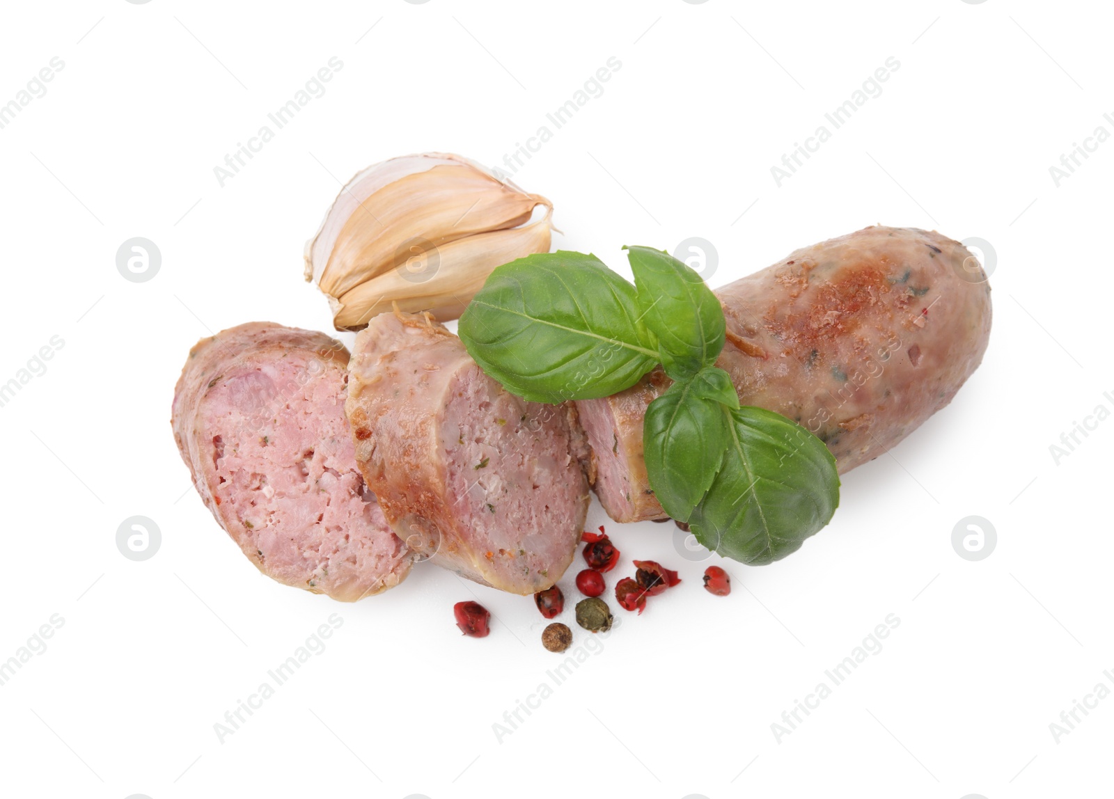 Photo of Tasty cut homemade sausage, garlic, peppercorns and basil leaves isolated on white