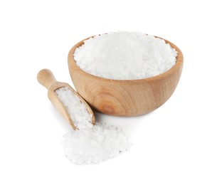 Wooden bowl and scoop with salt on white background