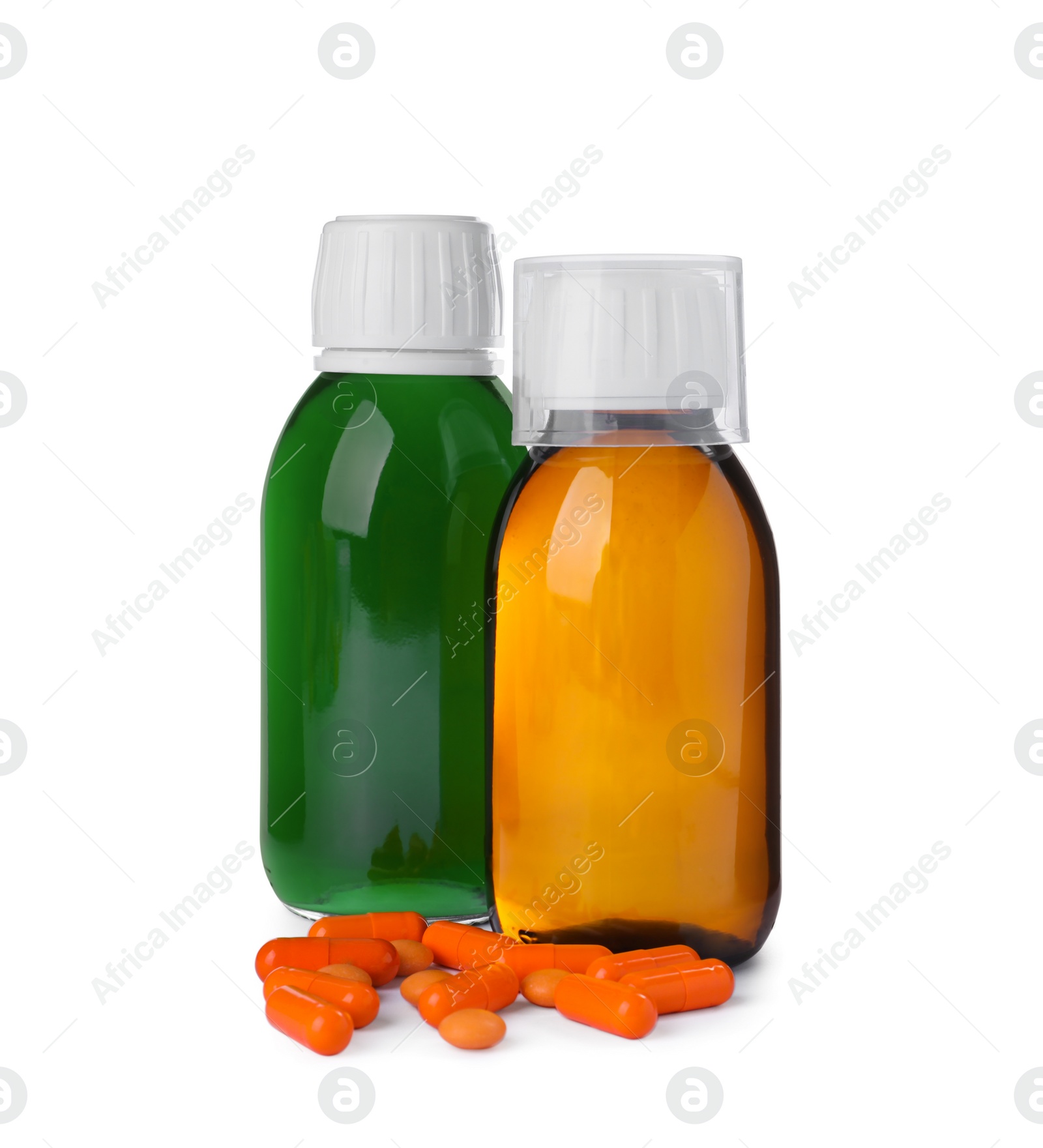 Photo of Bottles of syrups, measuring cup with pills on white background. Cough and cold medicine