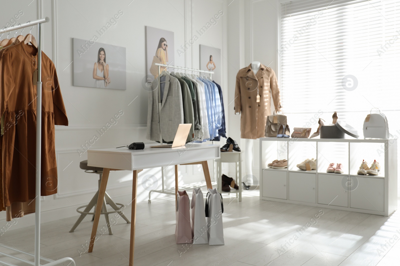 Photo of Collection of stylish women's clothes, shoes and accessories in modern boutique