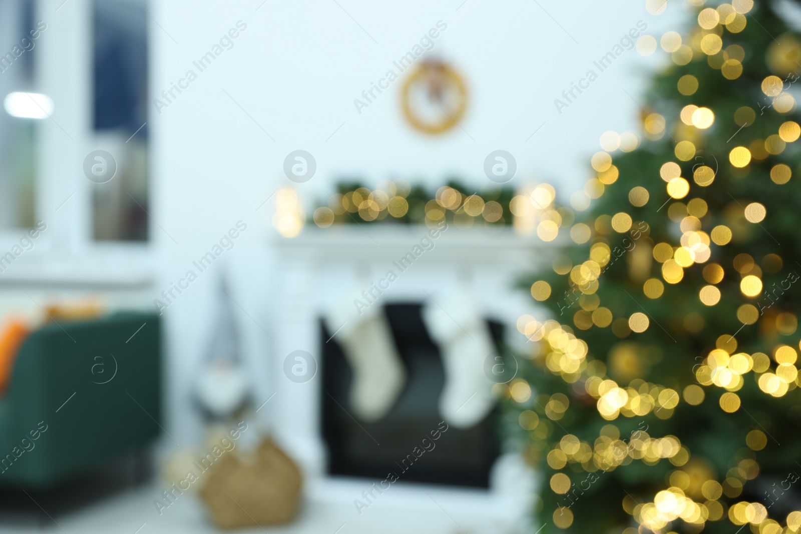 Photo of Blurred view of cozy living room with fireplace and Christmas tree. Interior design