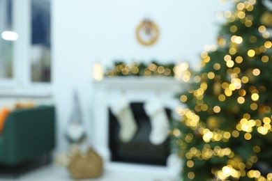Blurred view of cozy living room with fireplace and Christmas tree. Interior design