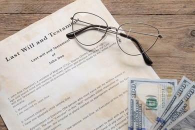 Photo of Last Will and Testament, dollar bills and glasses on wooden table, above view