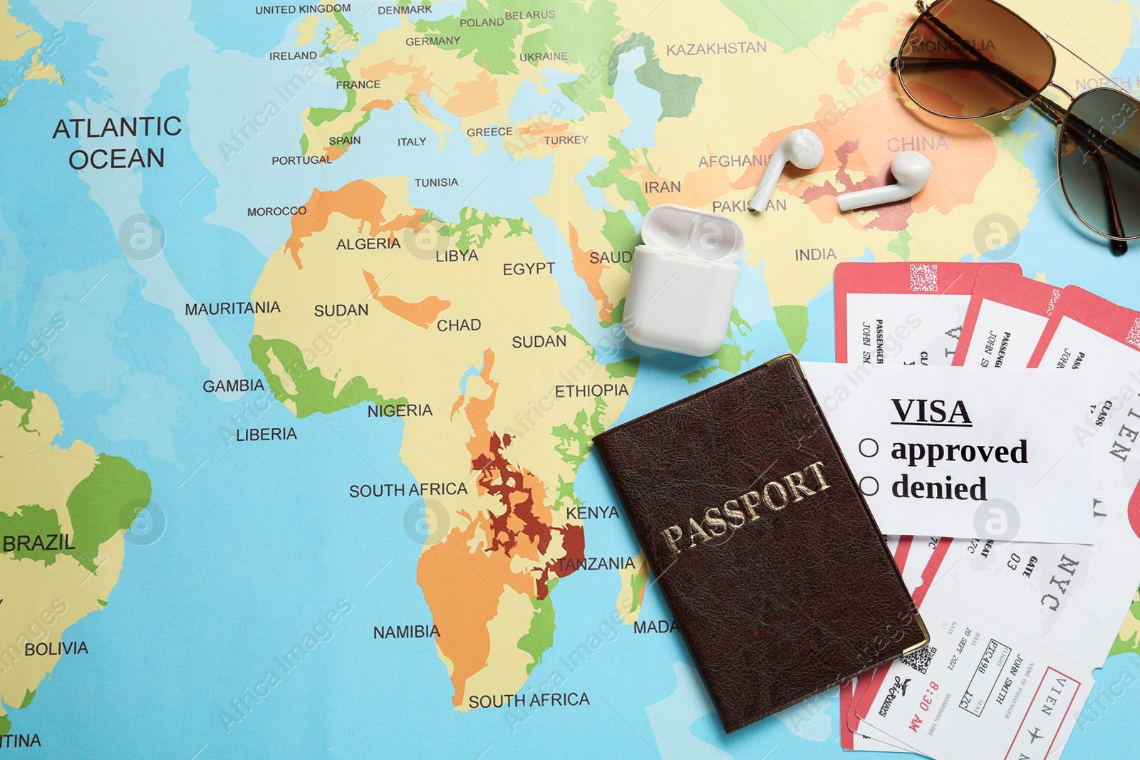 Photo of Flat lay composition with passport and tickets on world map. Space for text