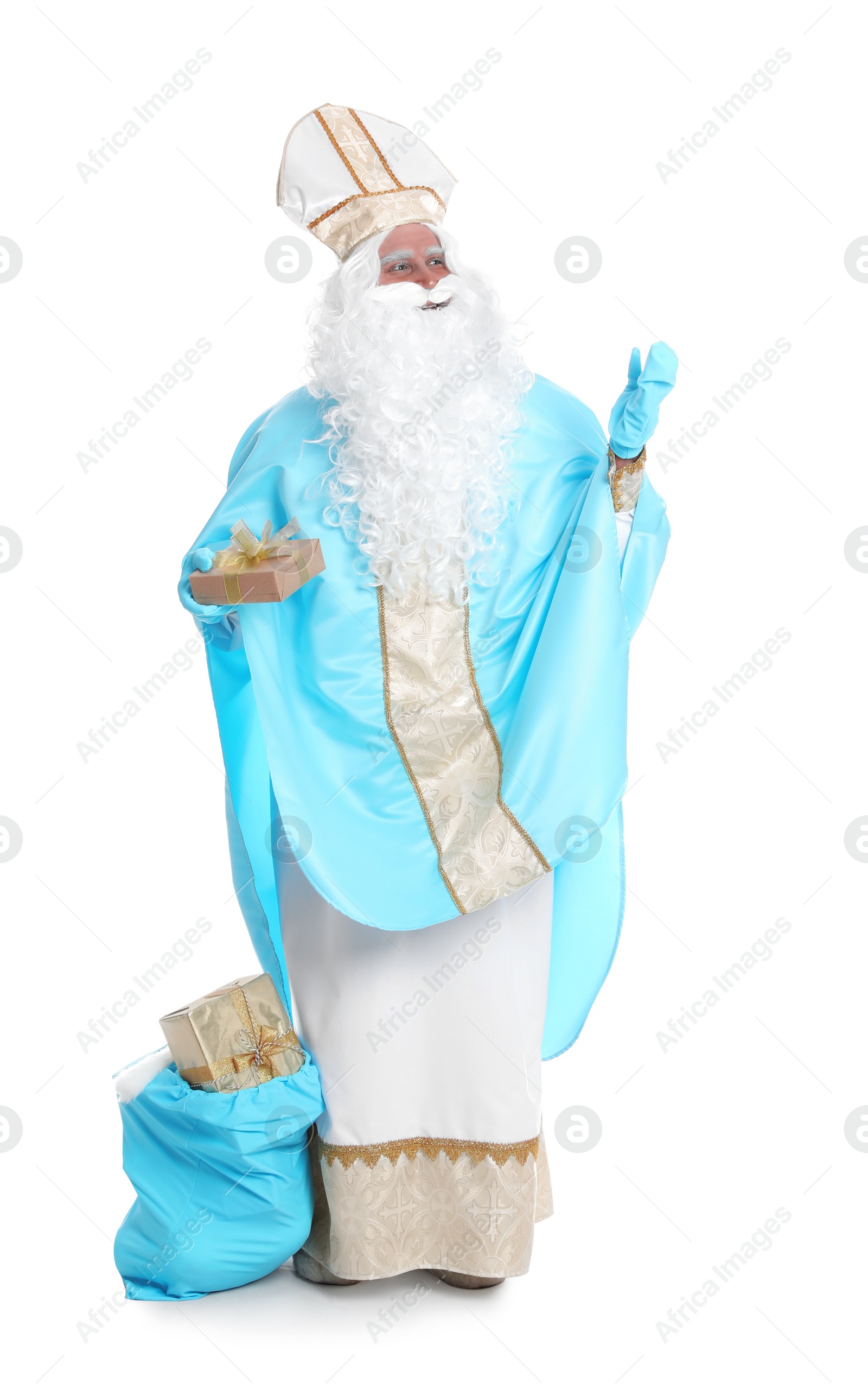 Photo of Full length portrait of Saint Nicholas near sack with presents on white background
